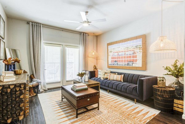 Spacious living room with modern decor at Monaco Midland Apartments