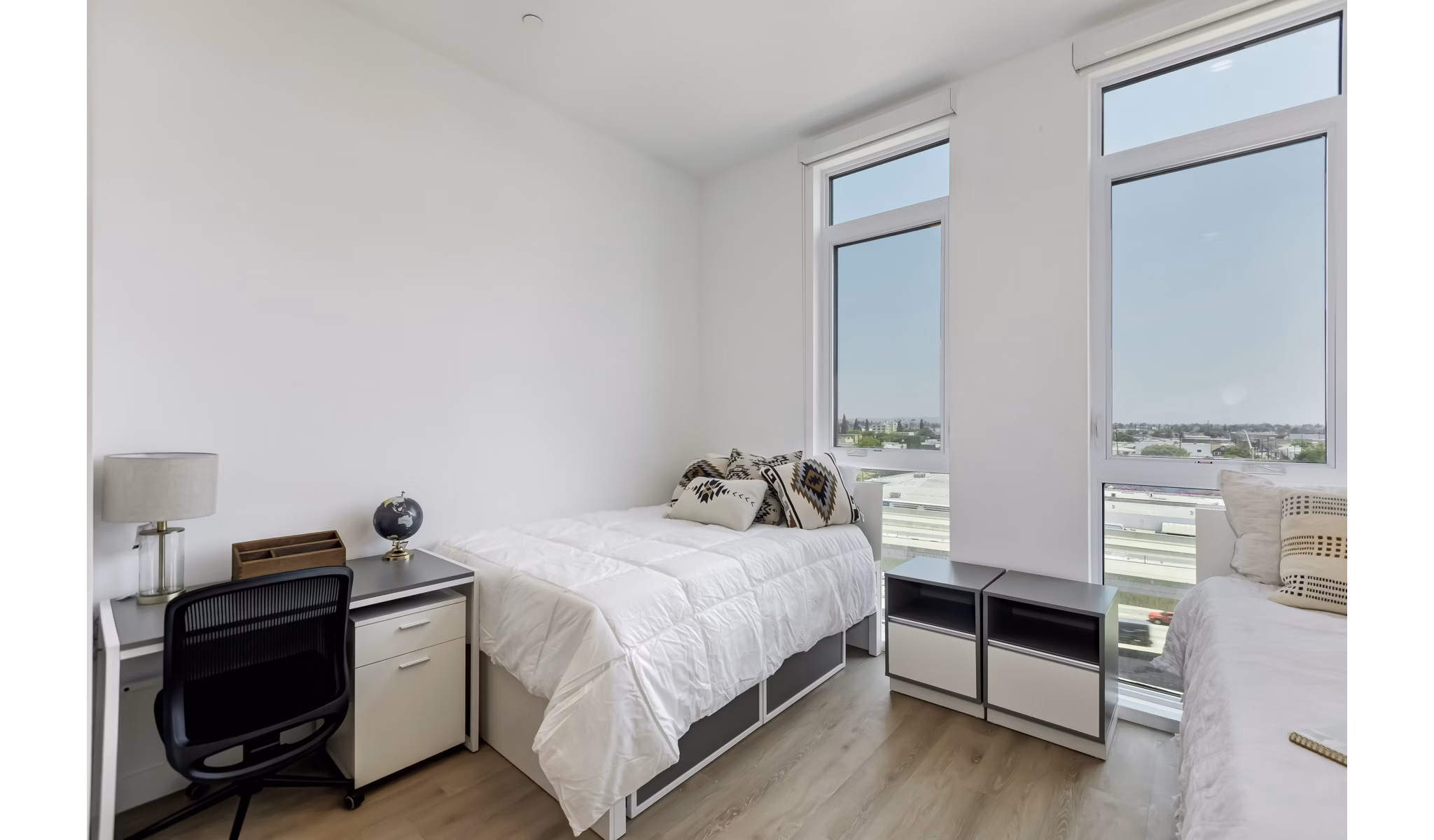 The 505 Apartments: Elegant bedroom featuring plush bedding and modern decor in downtown luxury setting