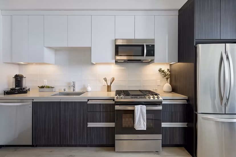 Modern kitchen featuring stainless steel appliances and island counter at The 505 Apartments