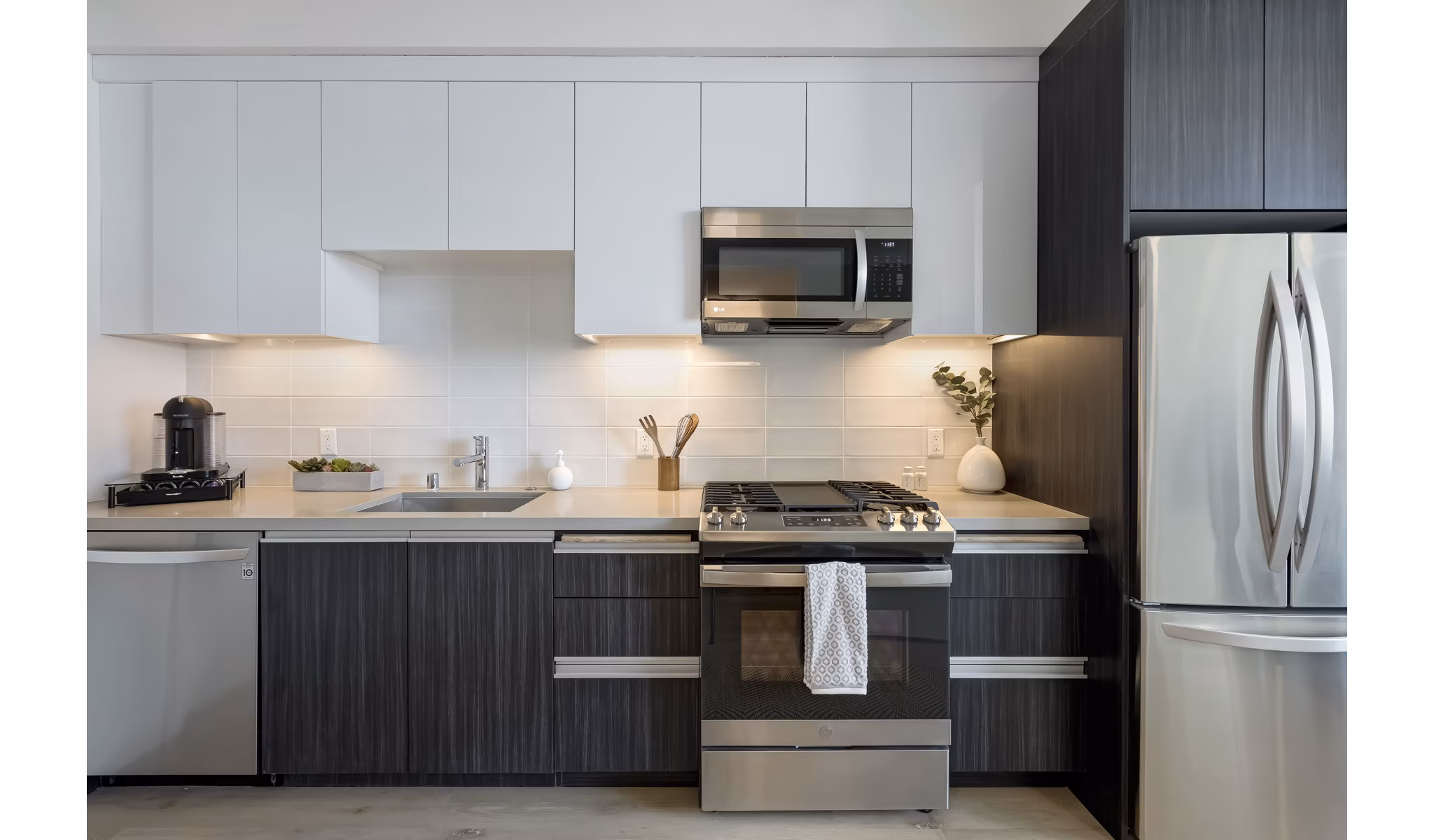 Modern kitchen featuring stainless steel appliances and island counter at The 505 Apartments
