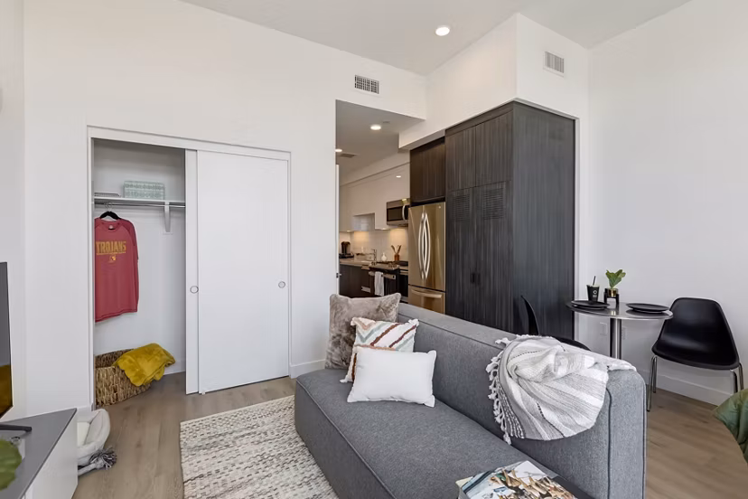 Spacious living room with modern decor and large windows in The 505 Apartments