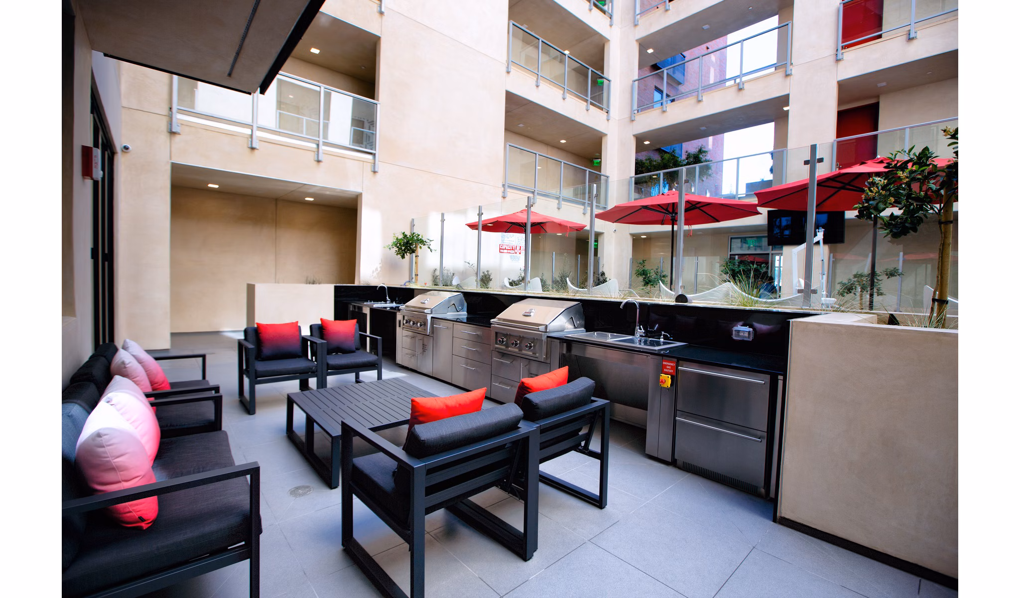 Modern outdoor grill area at The 505 Apartments with seating and lighting, perfect for social gatherings and alfresco dining