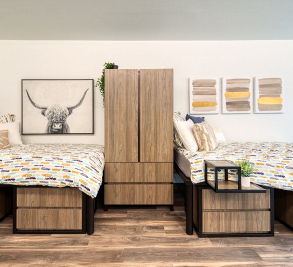 Luxurious bedroom with modern decor and large windows in The Durant Apartments