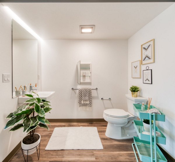 Bathroom featuring sleek fixtures and modern design at The Durant Apartments