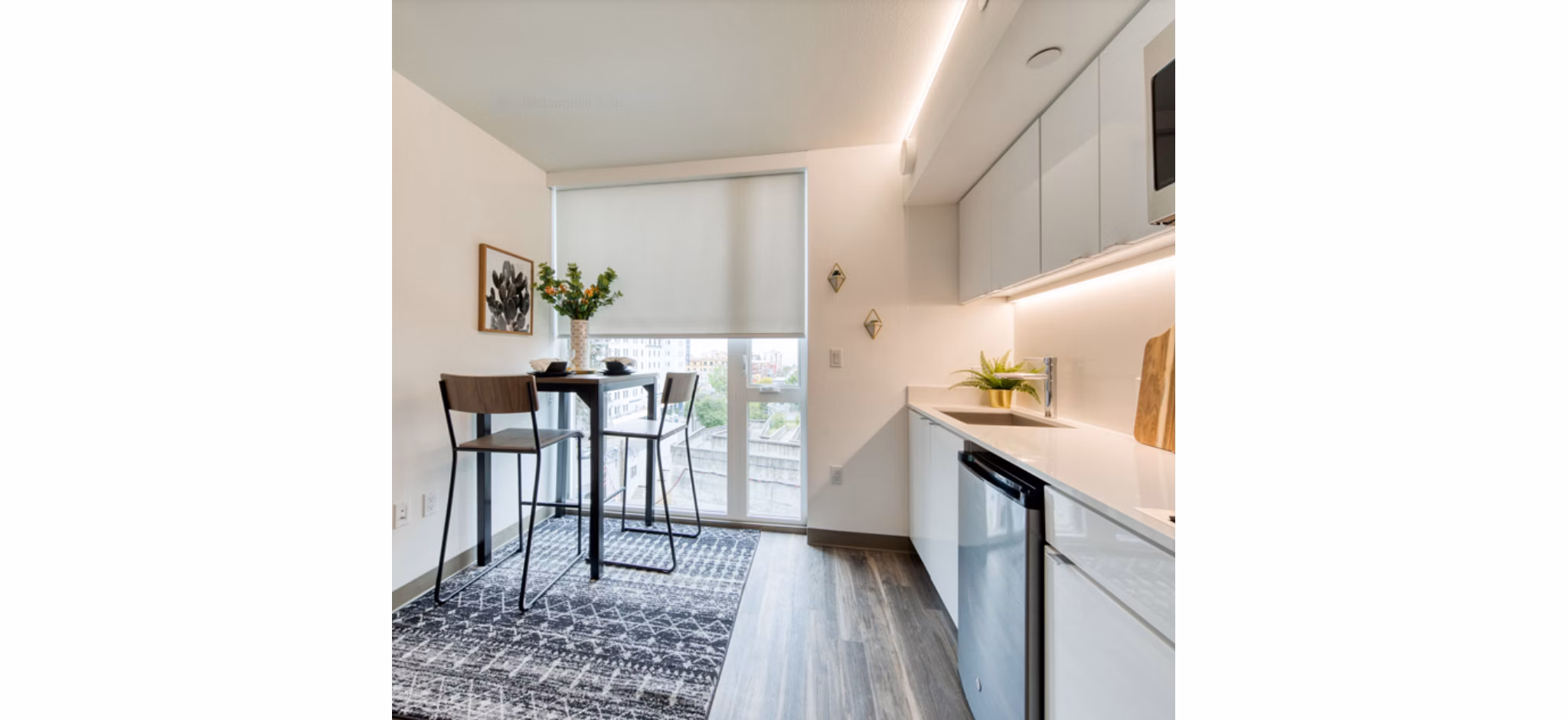 Modern kitchen with stainless steel appliances at The Durant Apartments