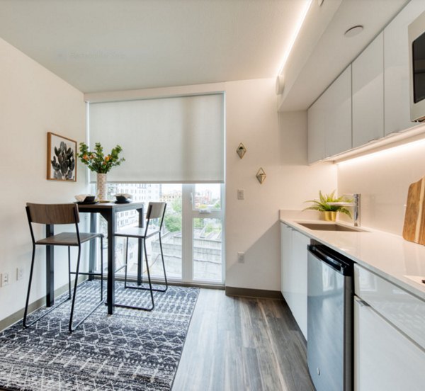 Modern kitchen with stainless steel appliances at The Durant Apartments