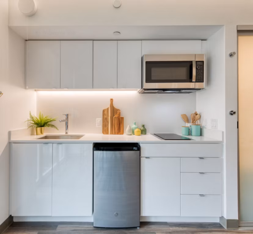 Modern kitchen with stainless steel appliances at The Durant Apartments