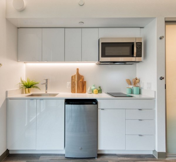 Modern kitchen with stainless steel appliances at The Durant Apartments