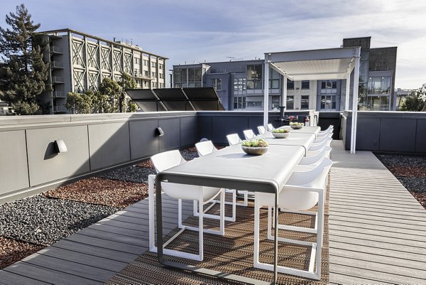 Scenic rooftop deck with lounge seating at The Durant Apartments, offering panoramic views for luxury living