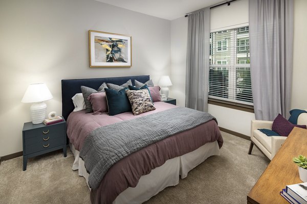 Cozy bedroom with stylish furnishings at Everleigh Duluth Apartments