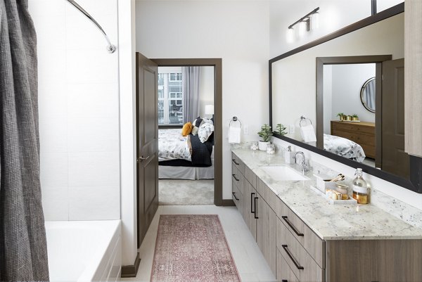 Everleigh Duluth Apartments: Modern bathroom featuring sleek fixtures and spacious vanity