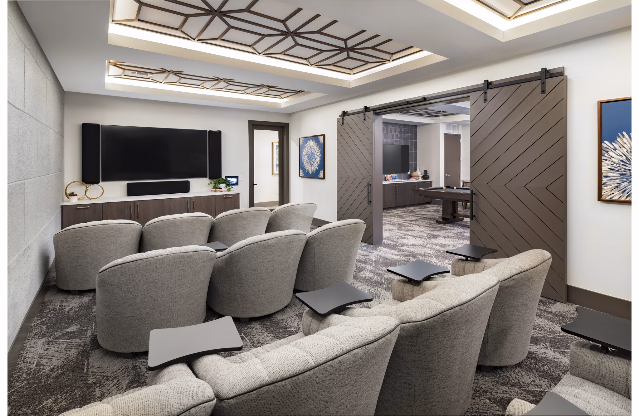 Theater room with plush seating and large screen at Everleigh Duluth Apartments