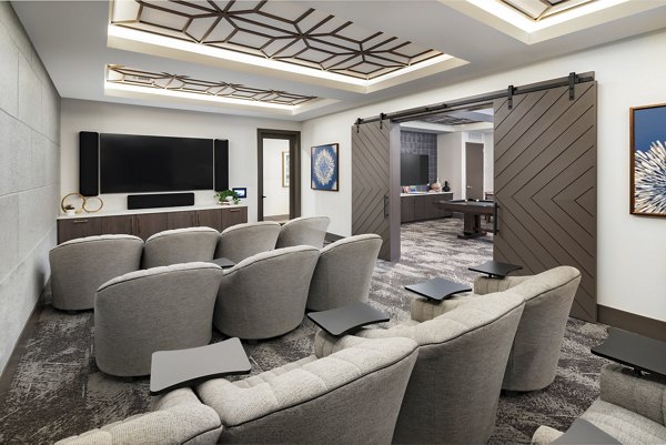 Theater room with plush seating and large screen at Everleigh Duluth Apartments