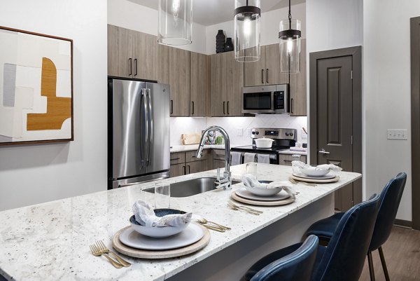 Modern kitchen with stainless steel appliances at Everleigh Duluth Apartments