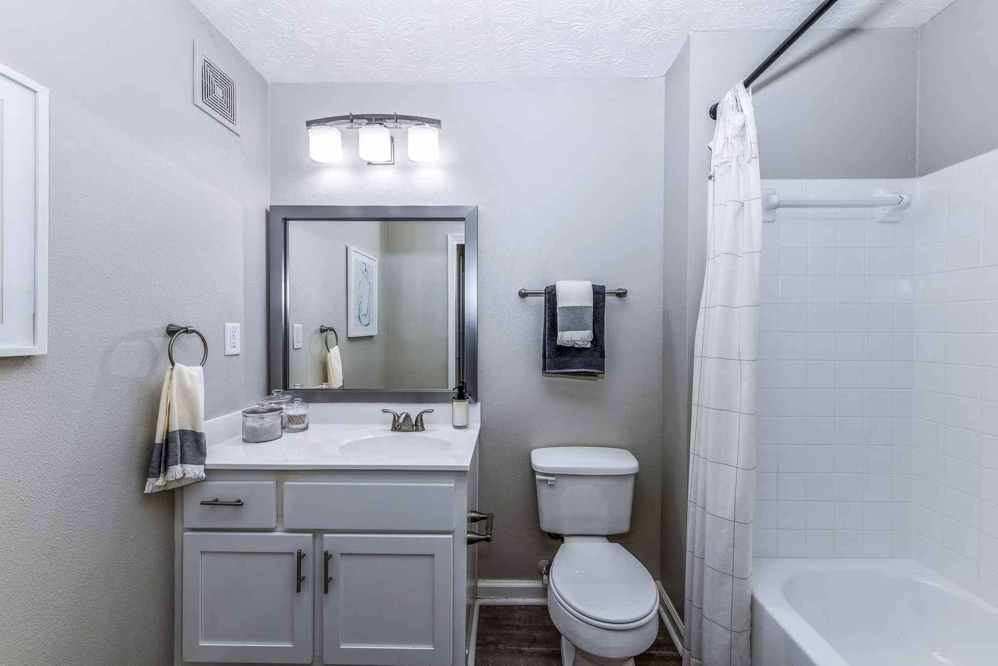 Modern bathroom featuring marble countertops and elegant fixtures at Avana Acworth apartments