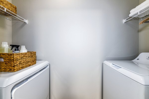 Laundry room at Avana Acworth Apartments featuring modern washers and dryers for convenient living