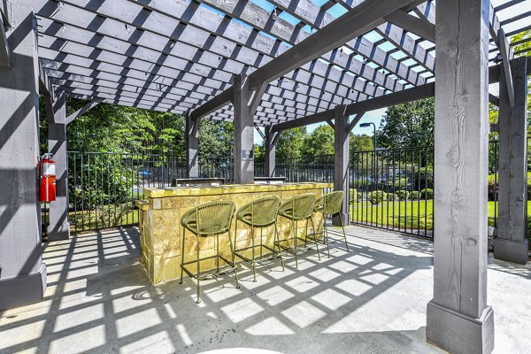 Grill area on spacious patio at Avana Acworth Apartments with modern seating and dining options