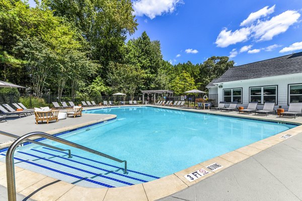 Relaxing pool at Avana Acworth Apartments with lounge seating, offering a luxurious outdoor retreat for residents