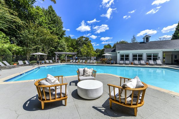Relaxing poolside area with lounge chairs and landscaping at Avana Acworth Apartments