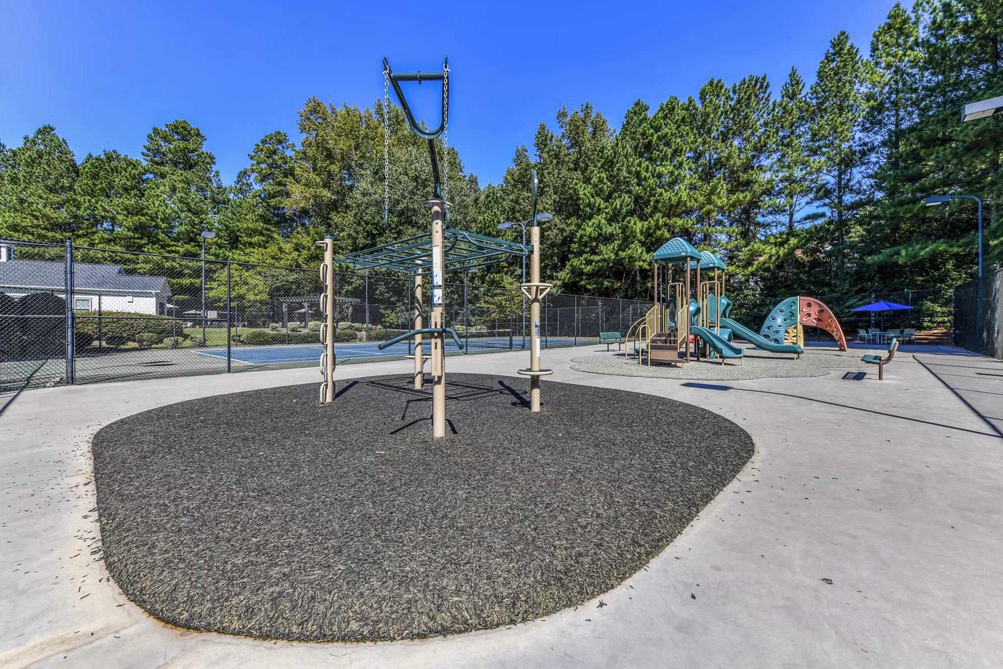 Colorful playground at Avana Acworth Apartments featuring slides and climbing structures for resident families