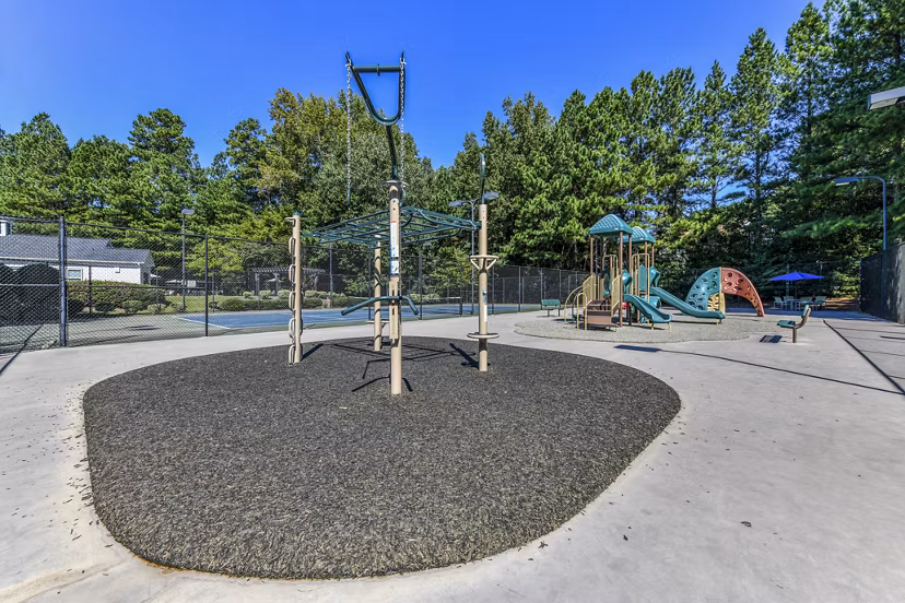 Colorful playground at Avana Acworth Apartments featuring slides and climbing structures for resident families