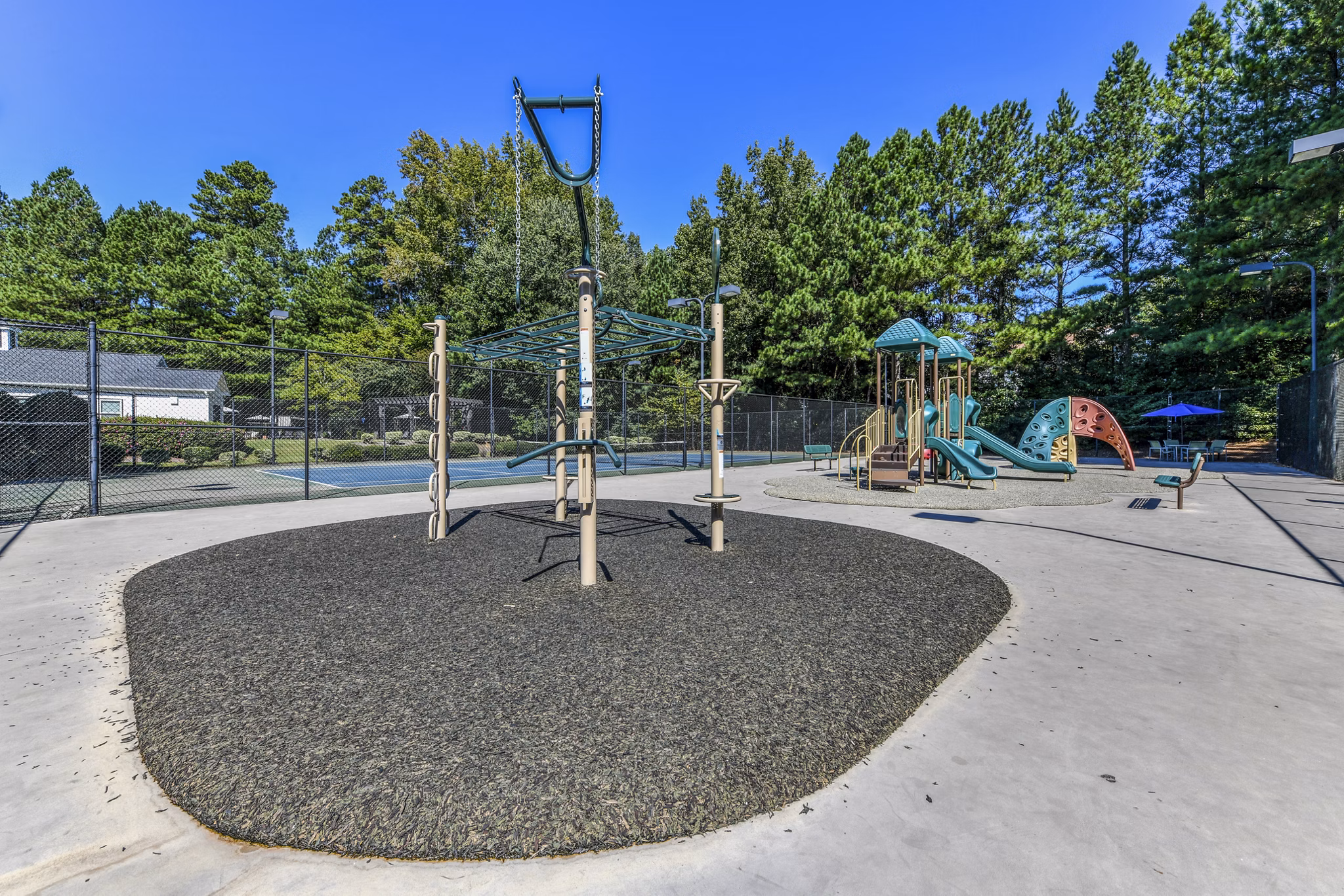 Colorful playground at Avana Acworth Apartments featuring slides and climbing structures for resident families
