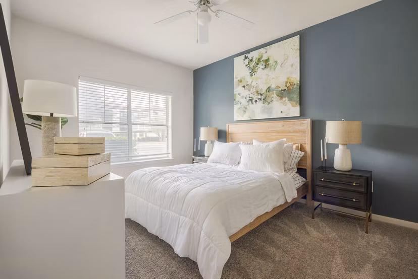Modern bedroom featuring chic decor and natural light at Avana SoCo Apartments
