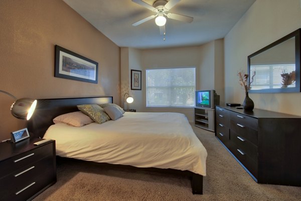 Modern bedroom featuring chic decor and natural light at Avana SoCo Apartments