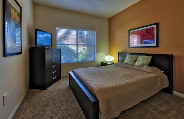 Modern bedroom with elegant furnishings at Avana SoCo luxury apartments in Austin, Texas