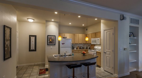 Modern kitchen featuring stainless steel appliances and island counter in Avana SoCo Apartments