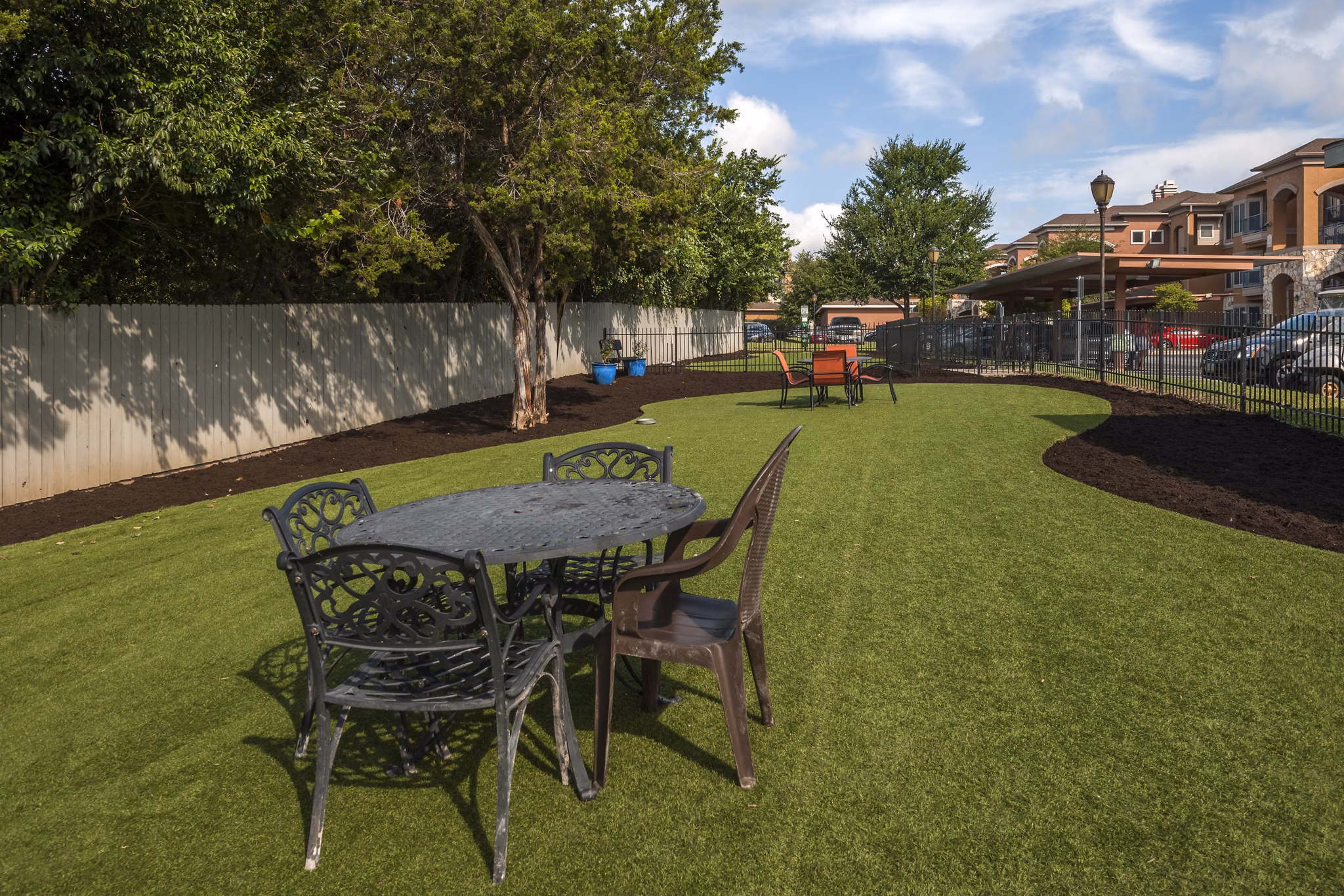 Outdoor recreational area with modern design at Avana SoCo Apartments, featuring seating and lush landscaping for residentsâ€™ enjoyment
