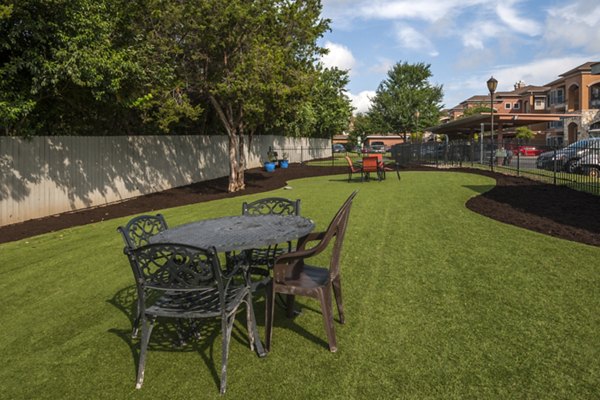 Outdoor recreational area with modern design at Avana SoCo Apartments, featuring seating and lush landscaping for residentsâ€™ enjoyment