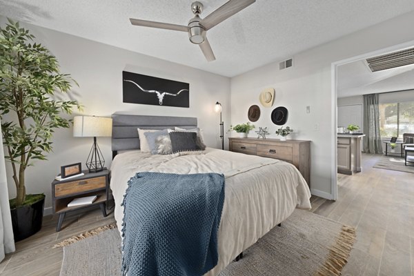 Bedroom with contemporary design and plush bedding in Solas Glendale Apartments