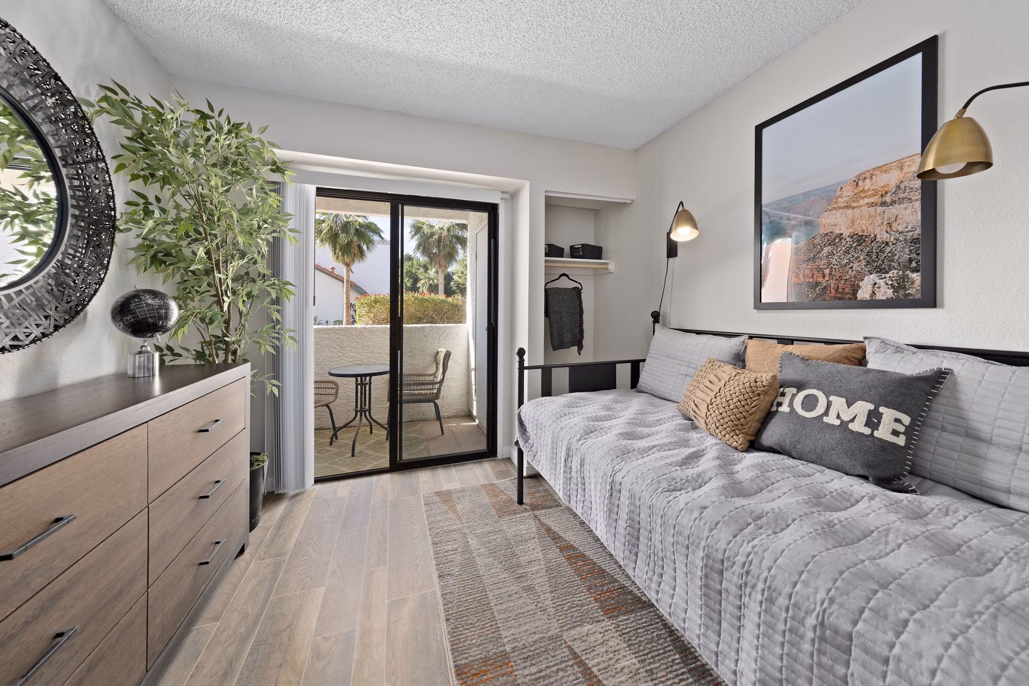 Bedroom with modern decor and large window at Solas Glendale Apartments, offering luxury living in a serene environment