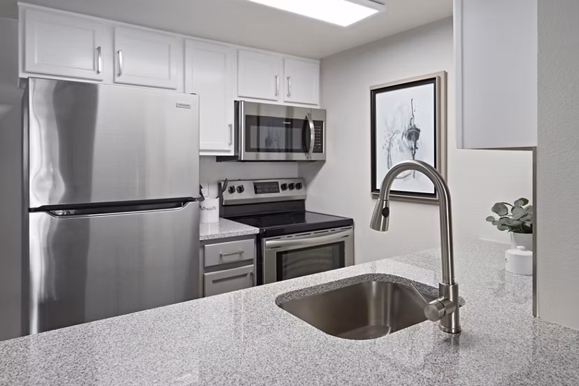 Modern kitchen with stainless steel appliances in Solas Glendale Apartments