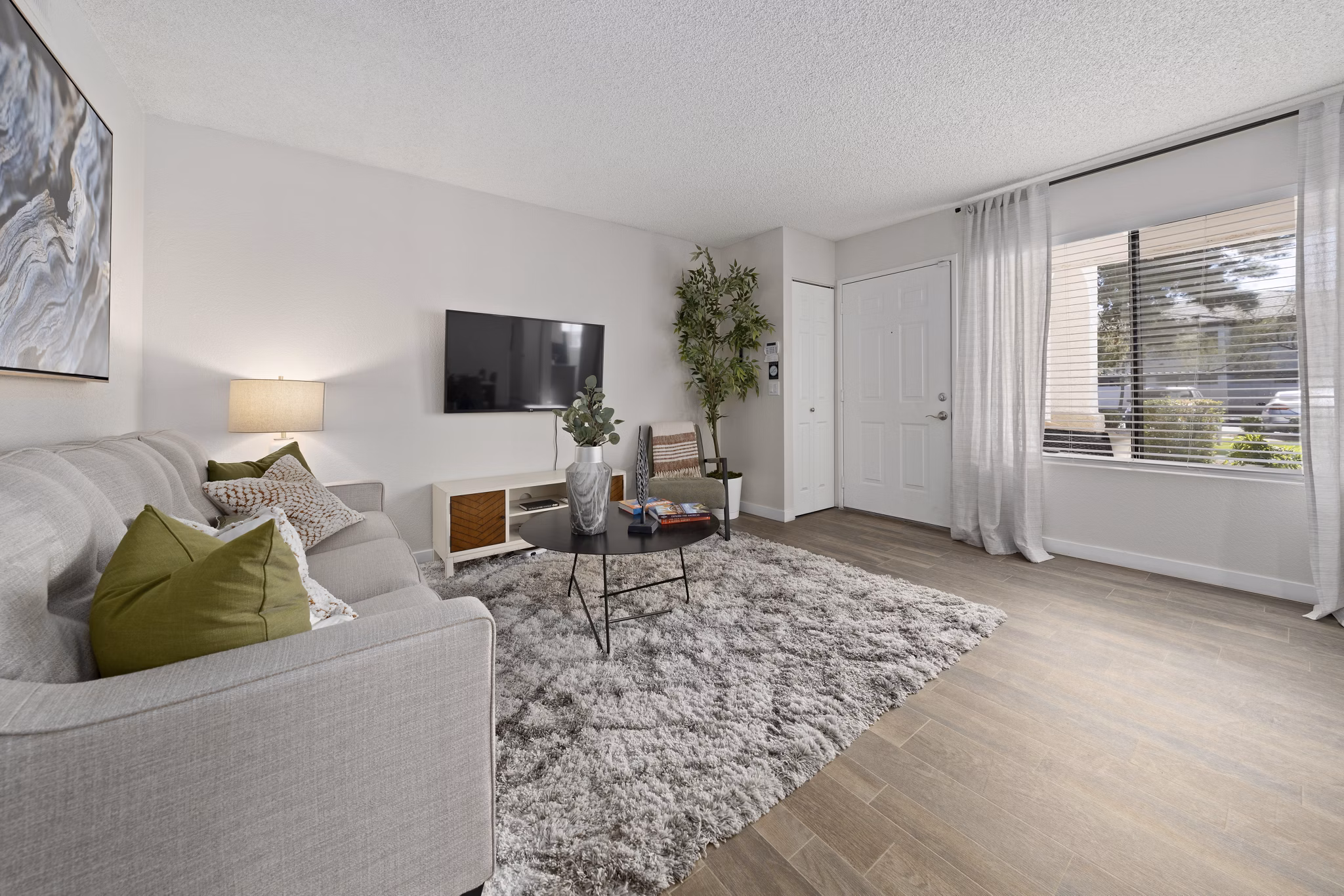 Spacious living room with modern furnishings and natural light at Solas Glendale Apartments