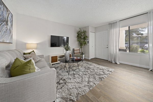 Spacious living room with modern furnishings and natural light at Solas Glendale Apartments