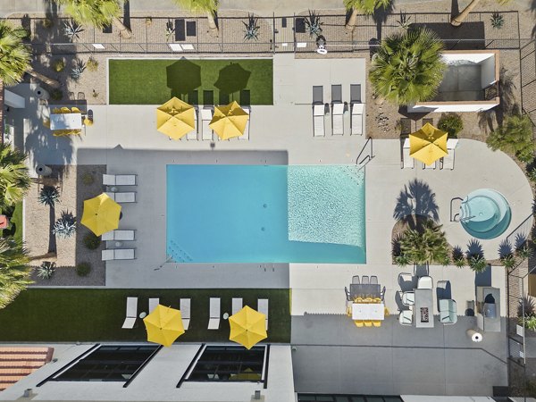 Resort-style pool with lounge chairs at Solas Glendale Apartments