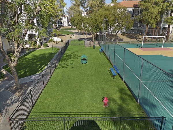 Shaded seating and play area at dog park in Solas Glendale Apartments