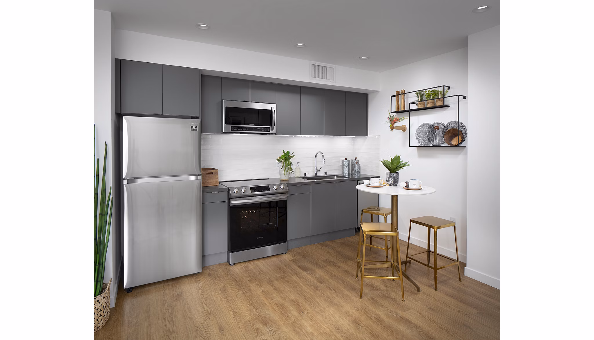 Kitchen featuring modern appliances and a sleek island at Cielo Apartments, luxury living in a prime location