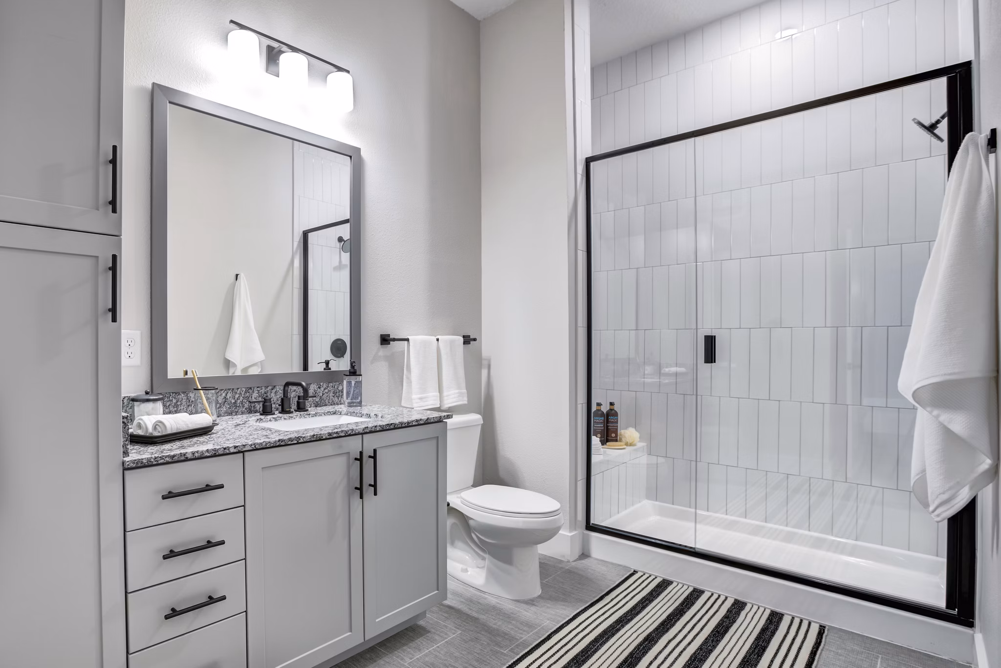 Bathroom featuring sleek fixtures and modern lighting at Prime Apartments