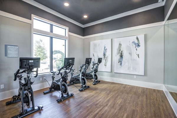 Yoga and spin studio with modern equipment at Prime Apartments, offering residents a space for wellness and fitness routines