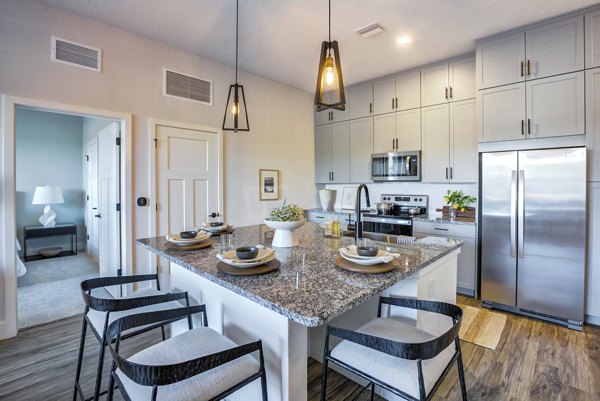 Modern kitchen featuring sleek countertops and stainless steel appliances at Prime Apartments