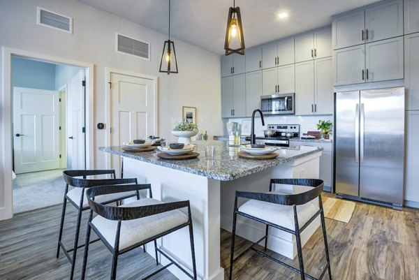 Modern kitchen with sleek countertops and stainless-steel appliances at Prime Apartments