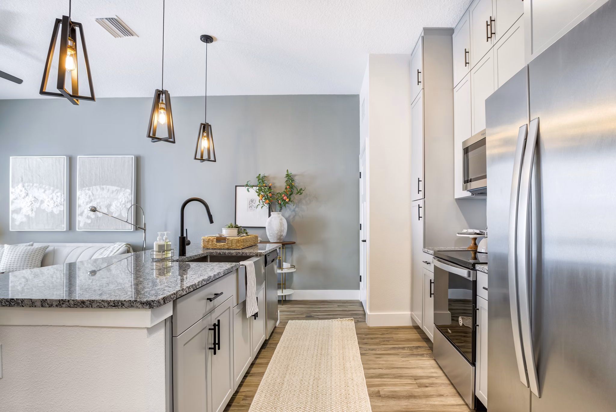 Modern kitchen featuring stainless steel appliances at Prime Apartments, a luxury living space in the heart of the city