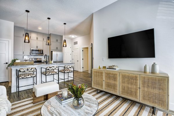 Cozy living room with modern decor and large windows in Prime Apartments