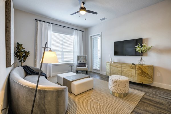 Spacious living room with modern dÃ©cor at Prime Apartments, perfect for comfort and style
