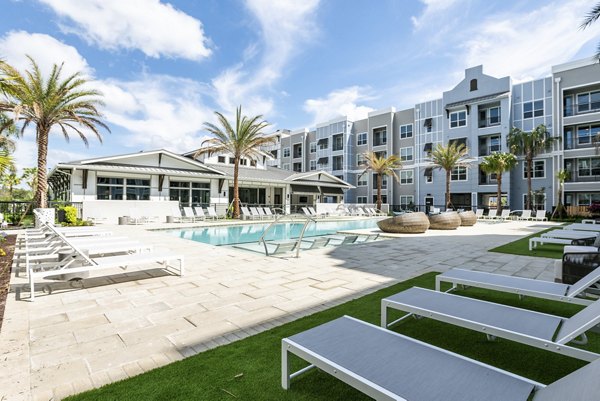Modern outdoor pool with lounge chairs at Prime Apartments, luxury living experience