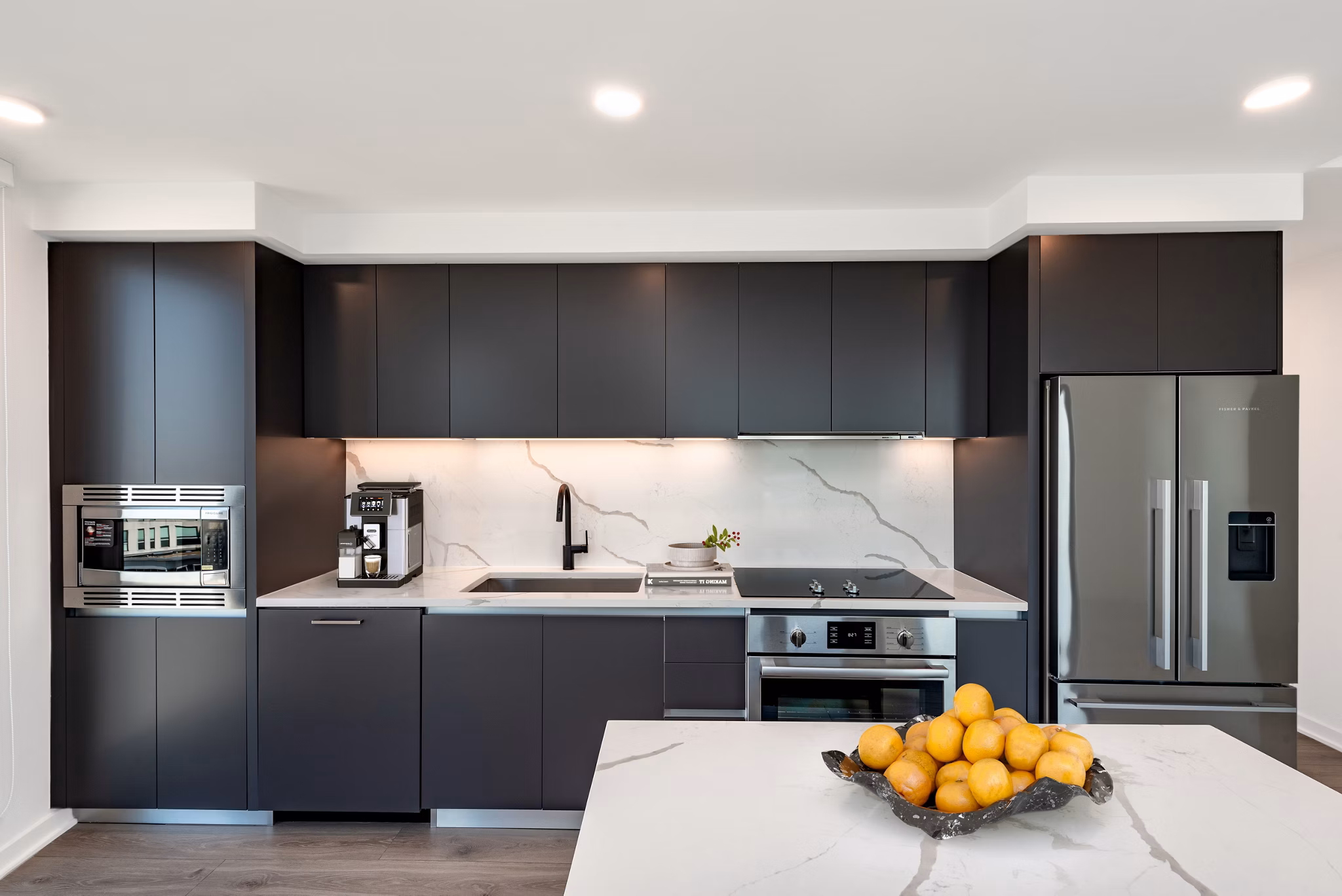 Modern kitchen featuring sleek countertops and stainless steel appliances at The Gantry Apartments, luxury living by Greystar