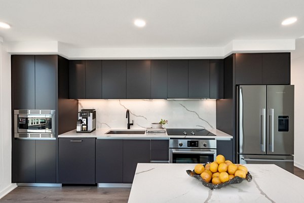 Modern kitchen featuring sleek countertops and stainless steel appliances at The Gantry Apartments, luxury living by Greystar